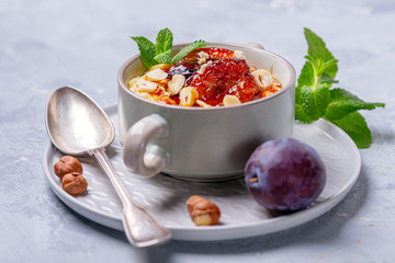 Millet porridge with caramelized plum for a healthy breakfast.