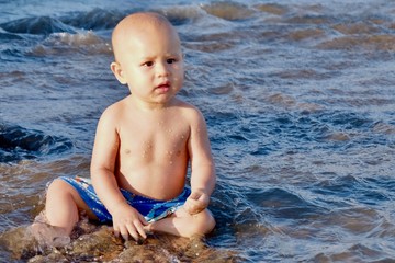 Baby​ New​born​ boy on the beach