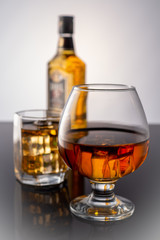 Bottle of whiskey and a glass of whiskey with ice