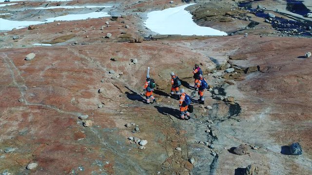 scientists in antarctica go and ride snowmobiles