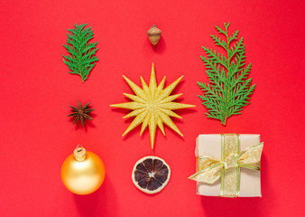 Holiday background ,set of christmas decorations, gift box and gold star with christmas ball, star anise with thuja twigs, acorn and dry citrus ,flat lay, top view