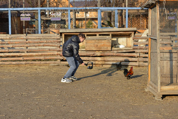 The guy the photographer runs after the chicken and shoots it on a video camera mounted on the steadic. Shooting a video on a ranch.