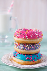 colorful doughnuts and glass of milk