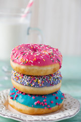 colorful doughnuts and glass of milk