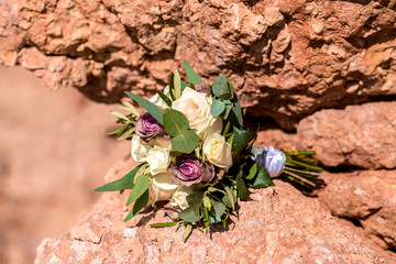 wedding bouquet of green and white flowers on the stone