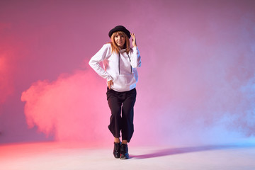 Pretty attractive female dancer performing dance element in dance show musical, keeping hand on...