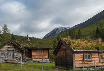 Traditional Scandinavian wooden cabins sod or turf roof house at a campsite in the Reinheim national Park. View from scenic road 63, Norway.