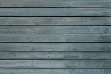 Texture blue wooden background. Background from several natural horizontal boards of blue color. The old painted.
