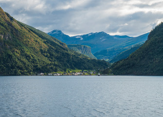 Beautiful Norwegian fjord. View across Storfjorden, towards village Eidsdal. Summer, blue sky. Norway