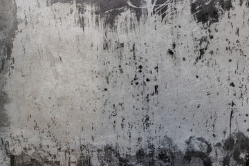 Texture of old gray concrete wall with spots, smudges, traces of paint, scratches, roughness for background