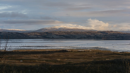 Mountains by a fjord with some snow in northern Norway