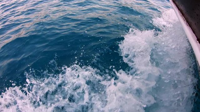 motor cruising boat breaks waves