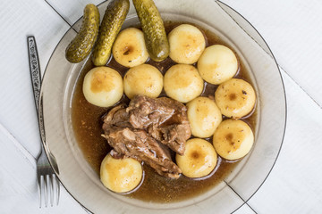 Stewed turkey meat served with silesian dumplings and sauce.