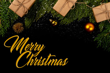 Christmas composition. Girlanda with Christmas ornaments and gifts on black background. Christmas, winter, new year concept. Flat lay, top view, copy space. © Julio Ricco