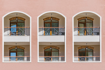 Windows and balconies of the new building at day time.