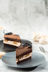 Banana chocolate cake on gray plate on marble background. Selective focus. Vertical photo. Menu for bakery. cafe menu. Pastry. Delicious and sweet dessert at cafe restaurant.