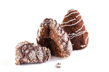 Two chocolate brownies . One is poured with white chocolate and sprinkled with cocoa, the second is poured with dark chocolate and sprinkled with coconut. Isolated on a white background.