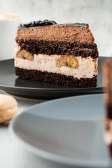 Banana chocolate cake on gray plate on marble background. Selective focus. Vertical photo. Menu for bakery. cafe menu. Pastry. Delicious and sweet dessert at cafe restaurant.