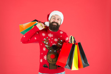 Organized shopper. Compulsive buyer. Retail. Almost christmas. Presents for family. Bearded hipster carry shopping bags. Santa man bought gifts. Christmas gifts. Guy in christmas sweater with deer