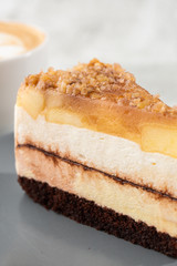 pear chocolate cake on gray plate on marble background. Selective focus. Vertical photo. Menu for bakery. cafe menu. Pastry. Delicious and sweet dessert at cafe restaurant.