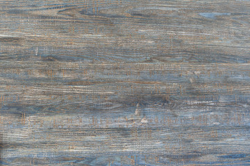 Naklejka premium Old wooden blue background. The texture of a scratched tree is one board. Traces of a cut of a tree with.