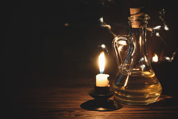 Obraz na płótnie Canvas Magic potion bottle on the table and mystic light around. Witchcraft. Alchemistry concept.