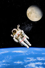 Astronaut at spacewalk. Cosmic art, science fiction wallpaper. Beauty of deep space. Billions of galaxies in the universe. “Elements of this image furnished by NASA”