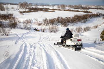 Rider on the snowmobile in nature of Siberia, Russia