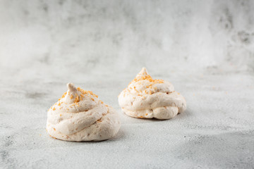Obraz na płótnie Canvas French meringue cookies, macro shot on bright marble background. Tray of meringues. Closeup meringue photo. Dessert background. Sweets. Food. Flat lay and copy space. Top view. Horizontal