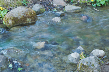 Stream flowing in between rocks. - 302064343