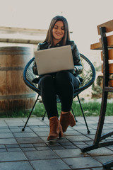 Fototapeta na wymiar Attractive woman sitting in modern coffee shop and working on laptop