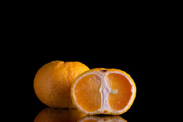 two oranges on a black background close-up
