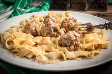 Tagliatelle pasta with beef meatballs.