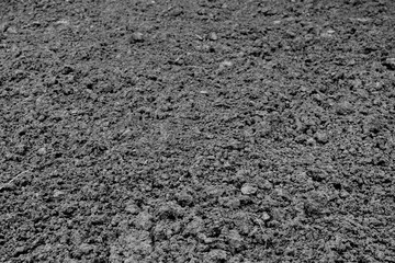 Black loose earth. Farmer plowed the field. Soil texture.