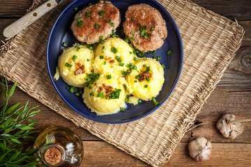 Meatballs served with boiled potatoes.