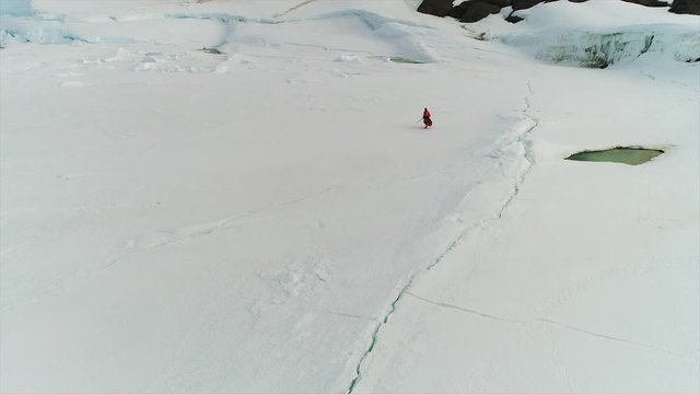 scientists in antarctica go and ride snowmobiles