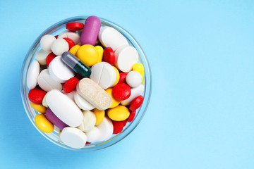 A bowl with colorful medicine pills	