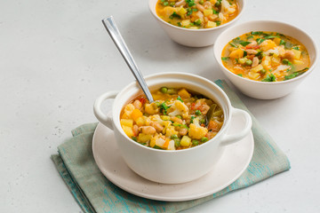 Homemade Italian minestrone - rustic vegetarian soup made with: beans, cauliflowers, onion, celery, carrots, tomatoes, potatoes, zucchini.