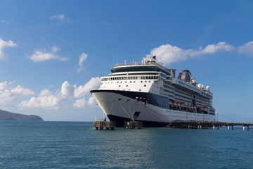 Fototapeta na wymiar Large beautiful cruise ship at sea and nice cloudy sky on background