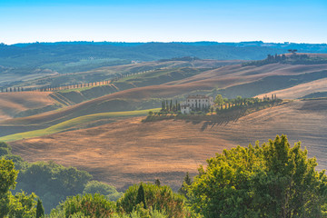 Fototapeta premium View of rural landscape with isolated farm house in the hills. Travel destination Tuscany, Italy
