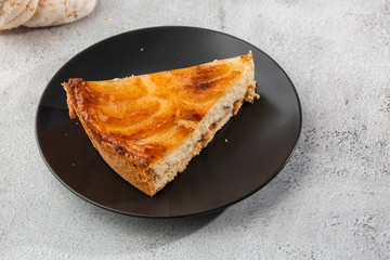 Homemade baked apple pie tart with apples cut in a decorative circular shape on top of flaky buttery crust on marble background. Rustic style. Copy space. Horizontal. menu for cafe