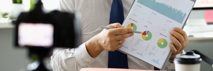 Male hand hold clipboard with business