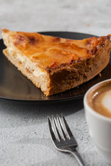 Homemade baked apple pie tart with apples cut in a decorative circular shape on top of flaky buttery crust on marble background. Rustic style. Copy space. Vertical. menu for cafe