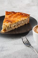 Homemade baked apple pie tart with apples cut in a decorative circular shape on top of flaky buttery crust on marble background. Rustic style. Copy space. Vertical. menu for cafe