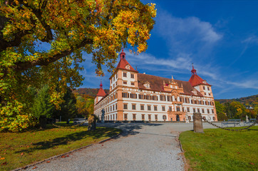 Obraz premium Colorful autumn colors, bright blue sky in the park and Eggenberg Palace in Graz, Styria region, Austria