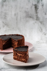 Delicious chocolate cake on plate on table on marble background. Wallpaper for pastry cafe or cafe menu. vertical.
