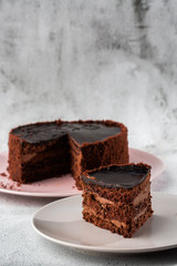 Delicious chocolate cake on plate on table on marble background. Wallpaper for pastry cafe or cafe menu. vertical.