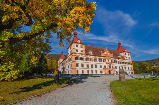 Colorful autumn colors, bright blue sky in the park and Eggenberg Palace in Graz, Styria region, Austria
