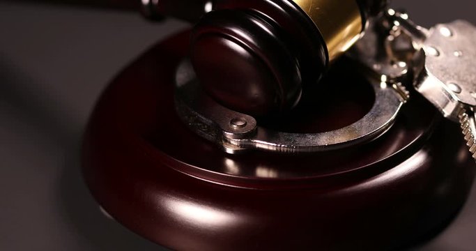 4k Handcuffs and Gavel Rotation Closeup On Dark Background.