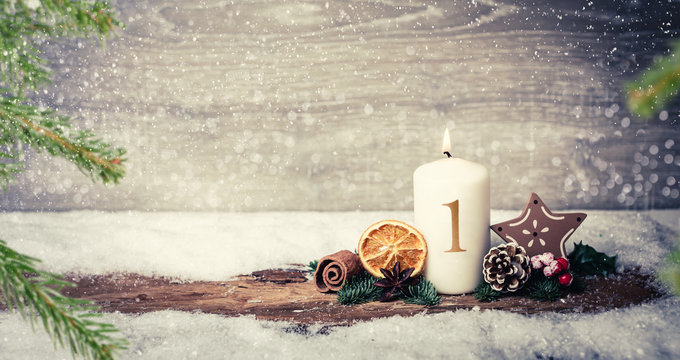 4th advent Christmas Eve with candle and number and snowy landscape